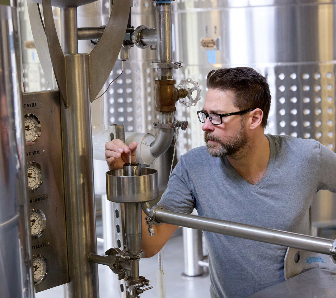 The owner thoughtfully gathering a rum sample.