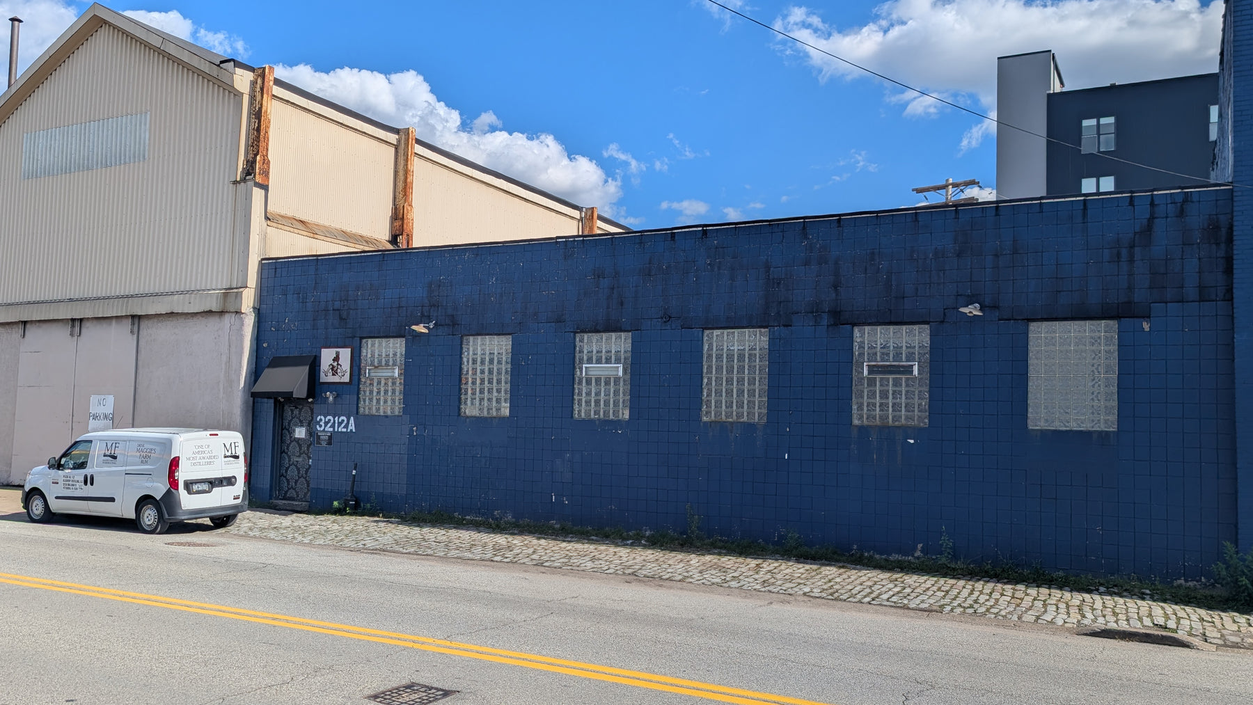 Front of Maggie's Farm Strip District. Blue building with glass block windows.